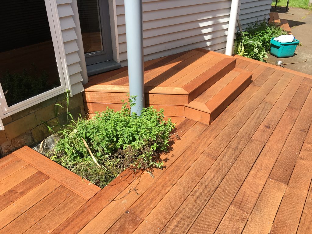 A brand new deck that has been added to an existing house