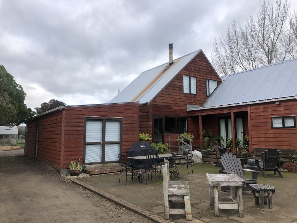 A house pre-renovation showing signs of wear on weatherboards and roof
