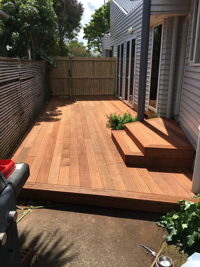 A brand new deck that has been added to an existing house