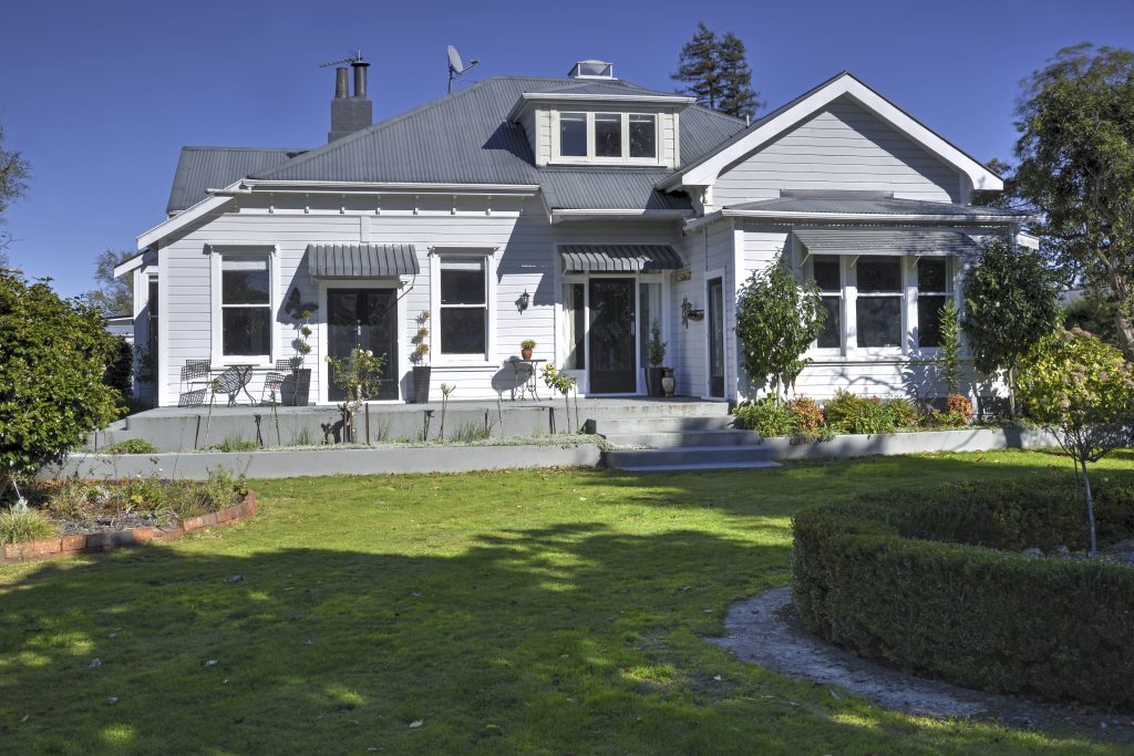 The exterior of a freshly renovated classically styled house.